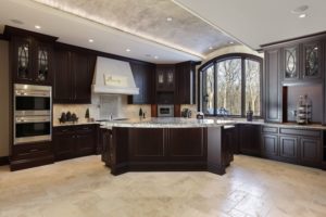 large kitchen in luxury home with dark wood cabinetry