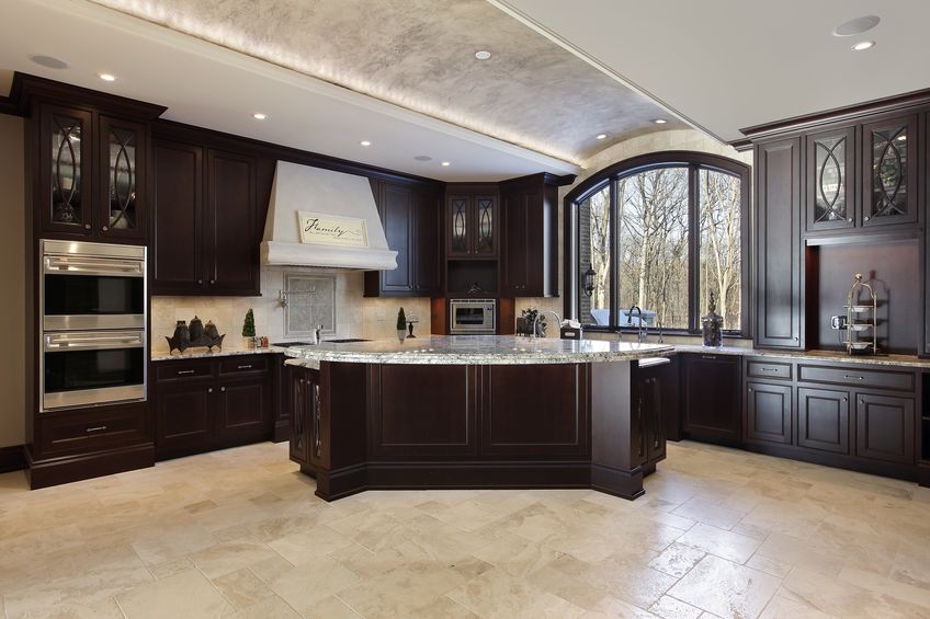  large kitchen in luxury home with dark wood cabinetry