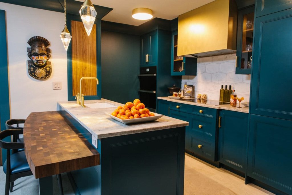 beautiful kitchen with a custom brass hood