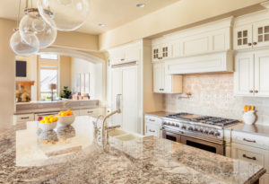 Kitchen with Island, Sink, Cabinets, and Hardwood Floors