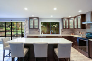 Updated contemporary kitchen room interior in white and brown tones.