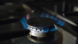 Gas stove burner and burning blue flame